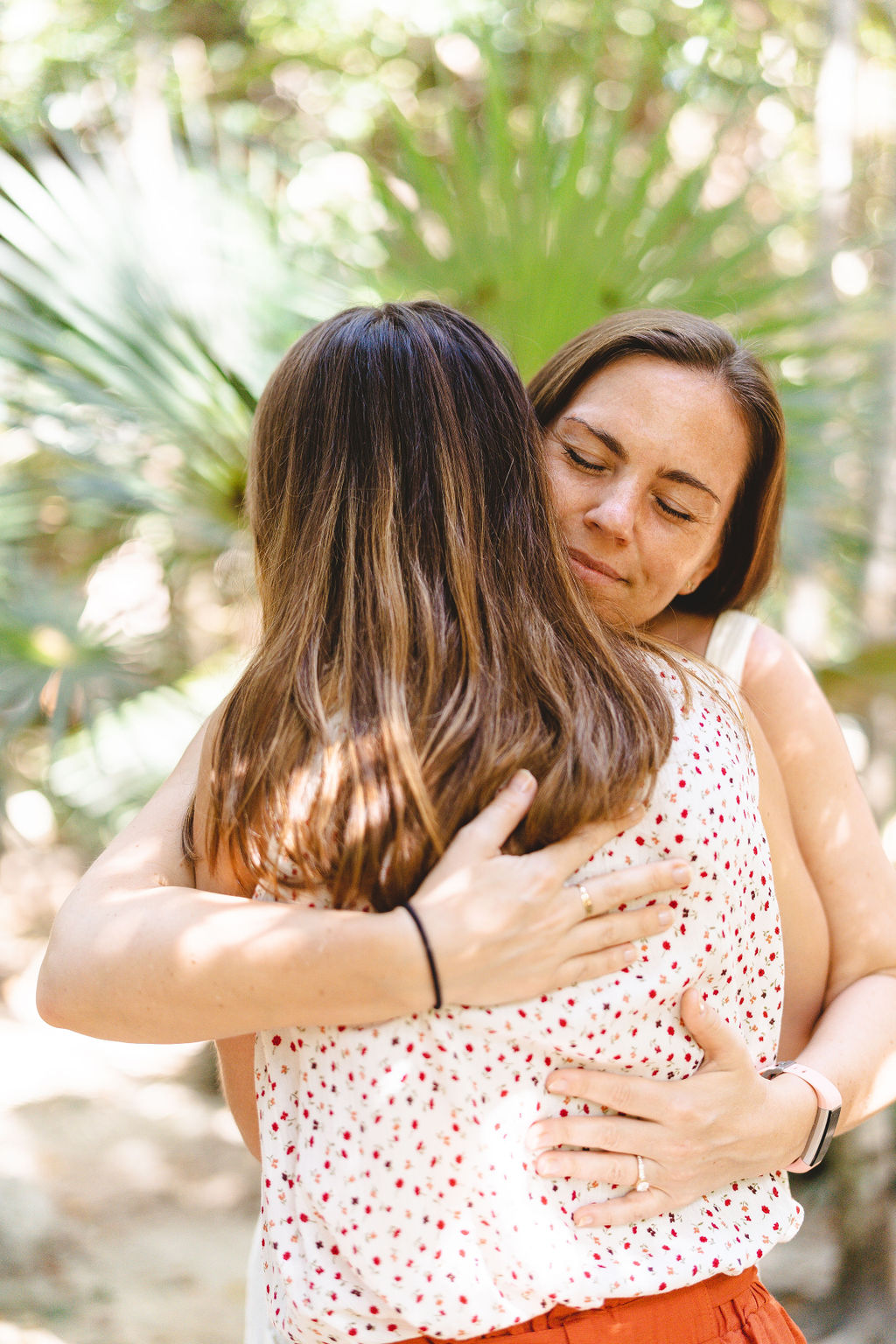Petia Burns embracing a woman outdoors